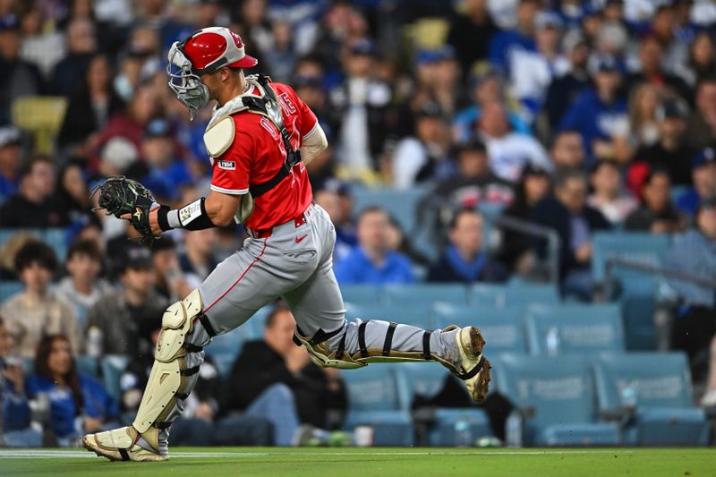 May 17, 2025; Los Angeles, California, USA; Los Angeles Angels catcher Logan O'Hoppe (14) runs after a loose ball against the Los Angeles Dodgers during the fifth inning at Dodger Stadium. Mandatory Credit: Jonathan Hui-Imagn Images