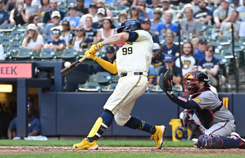 Jul 31, 2024; Milwaukee, Wisconsin, USA; Milwaukee Brewers catcher Gary Sanchez (99) hits a single against the Atlanta Braves in the seventh inning at American Family Field. Mandatory Credit: Michael McLoone-USA TODAY Sports