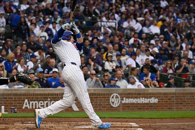 May 16, 2024; Chicago, Illinois, USA;   Chicago Cubs outfielder Ian Happ (8) hits a home run against the Pittsburgh Pirates during the second inning at Wrigley Field. Mandatory Credit: Matt Marton-USA TODAY Sports