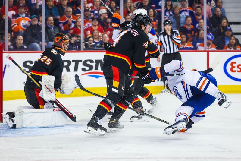 Apr 6, 2024; Calgary, Alberta, CAN; Calgary Flames defenseman Rasmus Andersson (4) checks Edmonton Oilers left wing Evander Kane (91) during the first period at Scotiabank Saddledome. Mandatory Credit: Sergei Belski-USA TODAY Sports