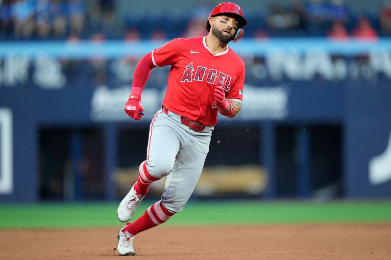 Aug 23, 2024; Toronto, Ontario, CAN; Los Angeles Angels center fielder Kevin Pillar (12) scores from first base against the Toronto Blue Jays on a double by Los Angeles Angels third baseman Anthony Rendon (not pictured) during the second inning at Rogers Centre. Mandatory Credit: John E. Sokolowski-USA TODAY Sports