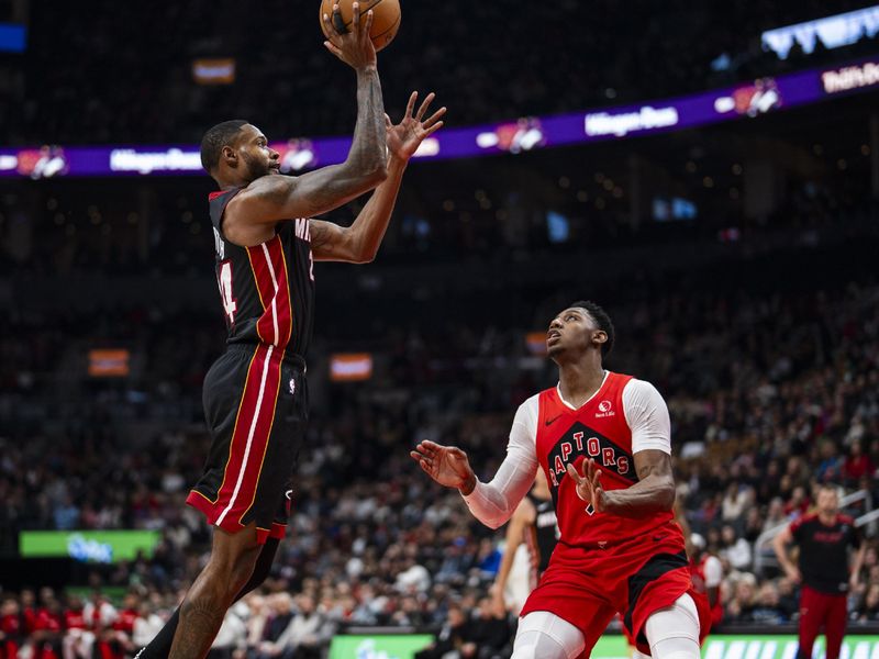 TORONTO, ON - DECEMBER 1: Haywood Highsmith #24 of the Miami Heat drives to the basket against RJ Barrett #9 of the Toronto Raptors at Scotiabank Arena on December 1, 2024 in Toronto, Ontario, Canada. NOTE TO USER: User expressly acknowledges and agrees that, by downloading and/or using this Photograph, user is consenting to the terms and conditions of the Getty Images License Agreement. (Photo by Andrew Lahodynskyj/Getty Images)