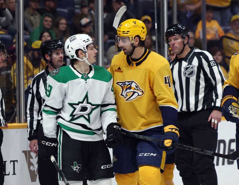 Nov 8, 2025; Nashville, Tennessee, USA; Dallas Stars center Justin Hryckowian (49) and Nashville Predators defenseman Nicolas Hague (41) exchange words as they are separated by refs during the second period at Bridgestone Arena. Mandatory Credit: Alan Poizner-Imagn Images