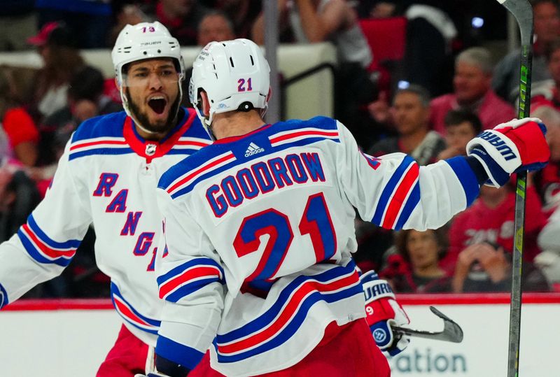 May 11, 2024; Raleigh, North Carolina, USA; New York Rangers center Barclay Goodrow (21) celebrates with defenseman K'Andre Miller (79) after scoring a goal against the Carolina Hurricanes during the second period in game four of the second round of the 2024 Stanley Cup Playoffs at PNC Arena. Mandatory Credit: James Guillory-USA TODAY Sports