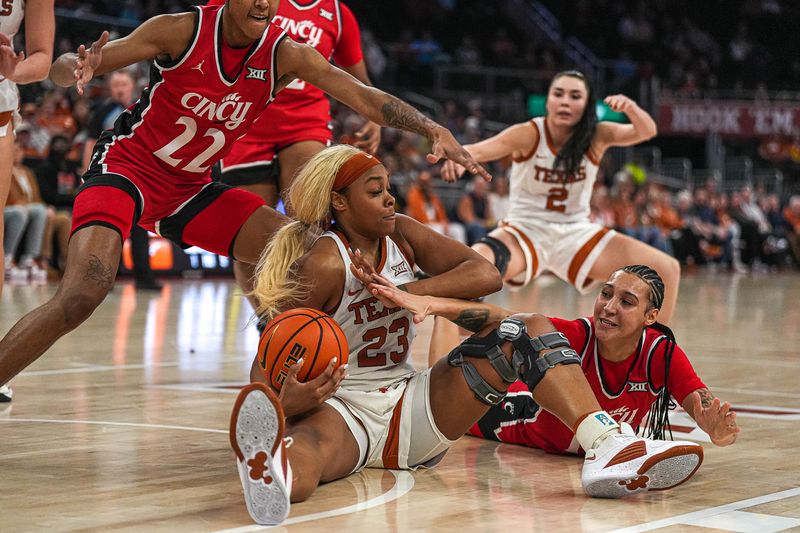 Jan 27, 2024; Austin, TX, USA; Texas Longhorns forward Aaliyah Moore (23) protects the ball against Cincinnati Bearcats guard Ta'Ziak Jenks (11) during a game at the Moody Center. Mandatory Credit: Aaron E. Martinez/American-Statesman via USA TODAY NETWORK