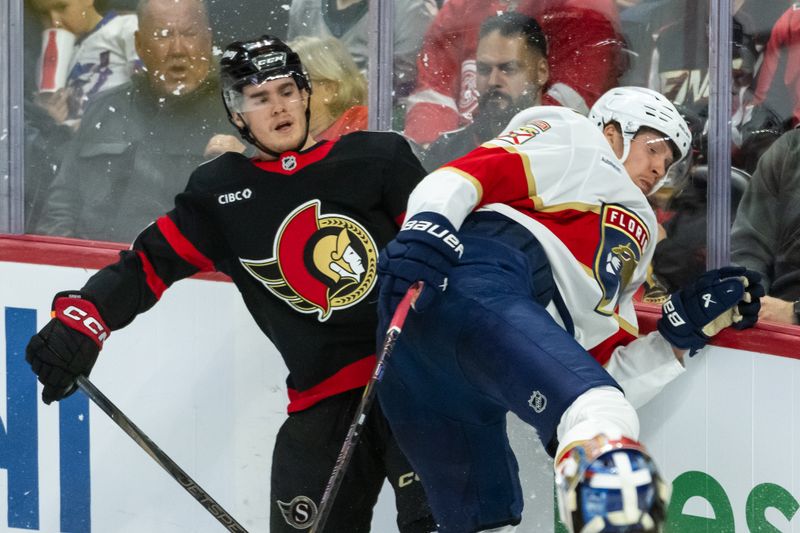 Apr 5, 2025; Ottawa, Ontario, CAN; Florida Panthers defenseman Niko Mikkola (77) is checked by Ottawa Senators center Ridly Greig (71) in the third period at the Canadian Tire Centre. Mandatory Credit: Marc DesRosiers-Imagn Images