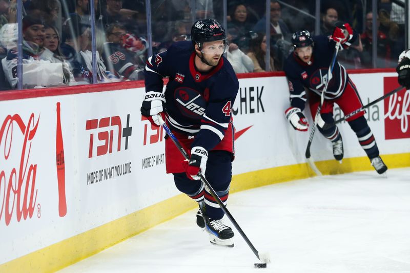 Nov 18, 2023; Winnipeg, Manitoba, CAN;  Winnipeg Jets defenseman Josh Morrissey (44) looks to make a pass against the Arizona Coyotes during the first period at Canada Life Centre. Mandatory Credit: Terrence Lee-USA TODAY Sports