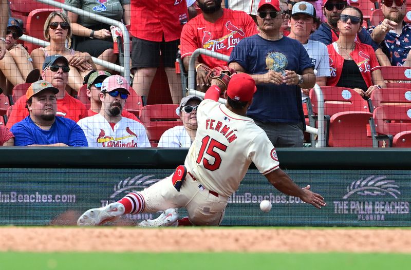 Jun 22, 2024; St. Louis, Missouri, USA; St. Louis Cardinals second baseman Jose Fermin (15) slides as he tries to catch an out of bounds ball hit by the Giants in the ninth innning at Busch Stadium. Mandatory Credit: Tim Vizer-USA TODAY Sports