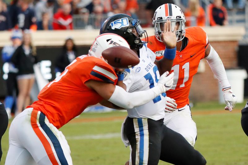 Oct 19, 2019; Charlottesville, VA, USA; Virginia Cavaliers linebacker Jordan Mack (4) forces a fumble by Duke Blue Devils quarterback Quentin Harris (18) in the third quarter at Scott Stadium. Mandatory Credit: Geoff Burke-USA TODAY Sports