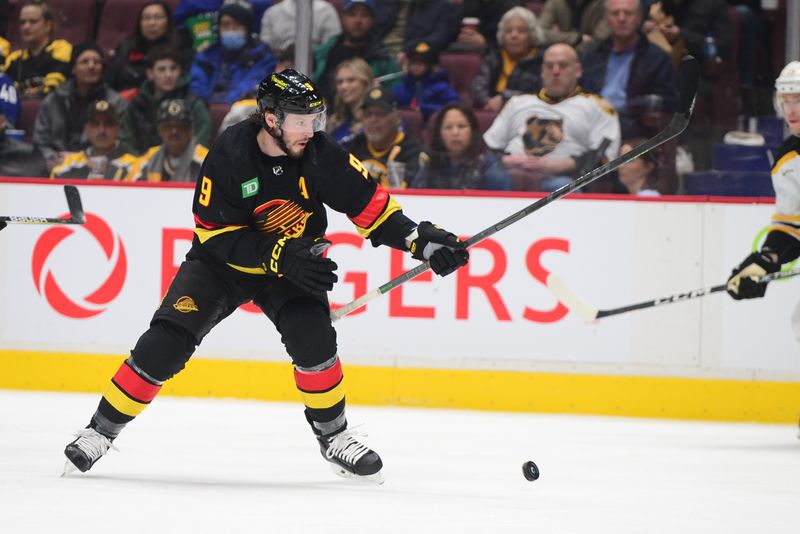 Feb 25, 2023; Vancouver, British Columbia, CAN; Vancouver Canucks forward J.T. Miller (9) reaches for the puck against the Boston Bruins during the first period at Rogers Arena. Mandatory Credit: Anne-Marie Sorvin-USA TODAY Sports