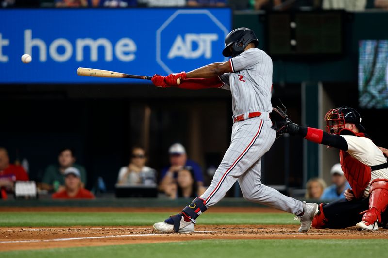 Sep 2, 2023; Arlington, Texas, USA; Minnesota Twins center fielder Michael A. Taylor (2) hits a two run double in the fourth inning against the Texas Rangers at Globe Life Field. Mandatory Credit: Tim Heitman-USA TODAY Sports