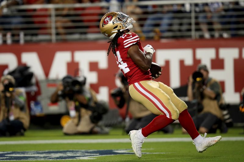 San Francisco 49ers running back Jordan Mason (24) runs for a touchdown during an NFL football game against the Dallas Cowboys, Sunday, Oct 8, 2023, in Santa Clara, Calif. (AP Photo/Scot Tucker)