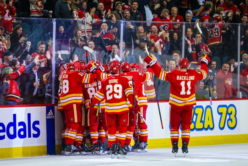 Nov 30, 2023; Calgary, Alberta, CAN; Calgary Flames celebrate after defeating Dallas Stars at Scotiabank Saddledome. Mandatory Credit: Sergei Belski-USA TODAY Sports