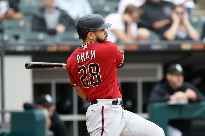 Sep 27, 2023; Chicago, Illinois, USA; Arizona Diamondbacks left fielder Tommy Pham (28) hits an RBI-single against the Chicago White Sox during the third inning at Guaranteed Rate Field. Mandatory Credit: Kamil Krzaczynski-USA TODAY Sports