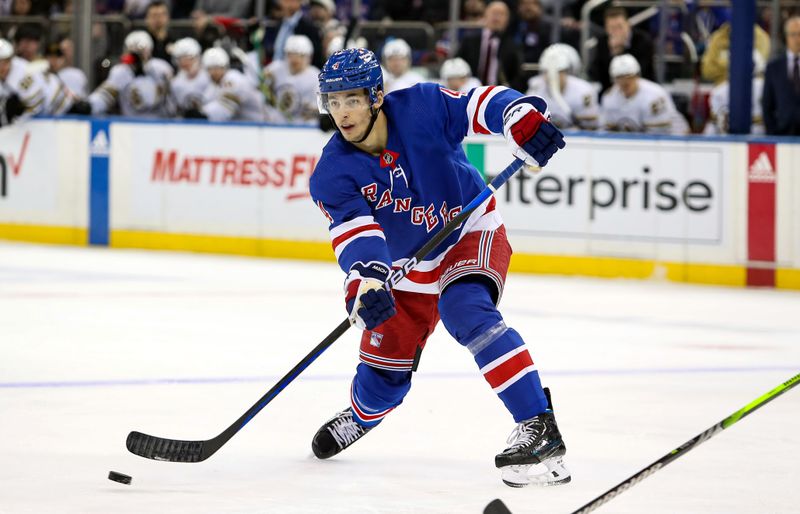 Nov 25, 2023; New York, New York, USA; New York Rangers defenseman Braden Schneider (4) passes the puck against the Boston Bruins during the second period at Madison Square Garden. Mandatory Credit: Danny Wild-USA TODAY Sports