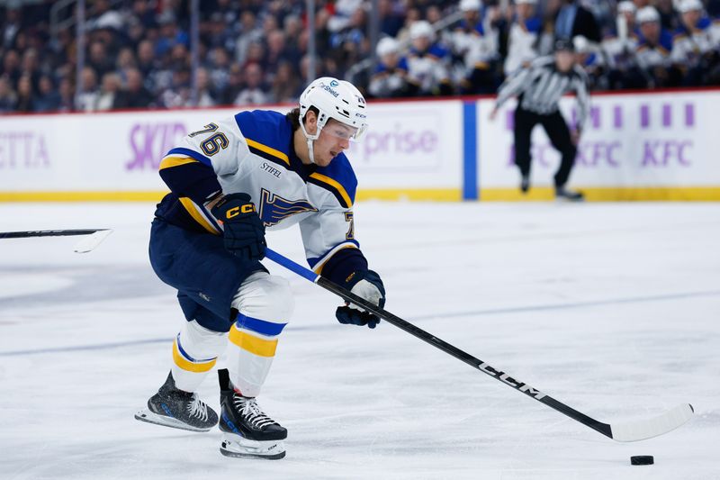 Dec 3, 2024; Winnipeg, Manitoba, CAN;  St. Louis Blues forward Zack Bolduc (76) controls the puck against the Winnipeg Jets during the first period at Canada Life Centre. Mandatory Credit: Terrence Lee-Imagn Images