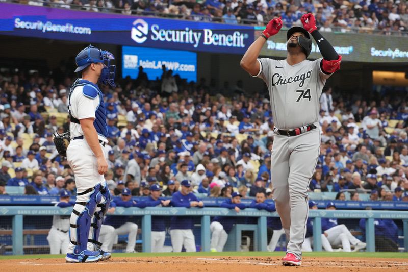 Jun 15, 2023; Los Angeles, California, USA; Chicago White Sox designated hitter Eloy Jimenez (74) celebrates after hitting a home run in the first inning as Los Angeles Dodgers catcher Will Smith (16) watches at Dodger Stadium. Mandatory Credit: Kirby Lee-USA TODAY Sports