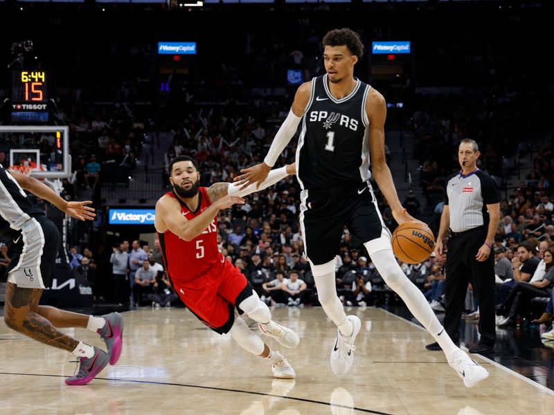 SAN ANTONIO, TX - OCTOBER 28: Victor Wembanyama #1 of the San Antonio Spurs dribbles the ball past Fred VanVleet #5 of the Houston Rockets in the second half at Frost Bank Center on October 28, 2024 in San Antonio, Texas. NOTE TO USER: User expressly acknowledges and agrees that, by downloading and or using this photograph, User is consenting to terms and conditions of the Getty Images License Agreement. (Photo by Ronald Cortes/Getty Images)