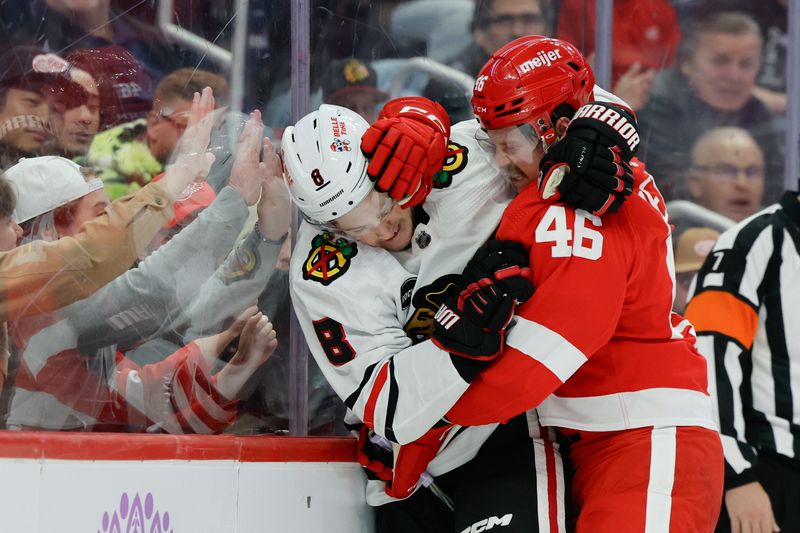 Nov 30, 2023; Detroit, Michigan, USA;  Chicago Blackhawks center Ryan Donato (8) and Detroit Red Wings defenseman Jeff Petry (46) grab each other in the first periodat Little Caesars Arena. Mandatory Credit: Rick Osentoski-USA TODAY Sports