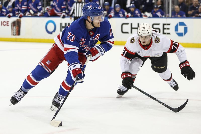 Nov 1, 2024; New York, New York, USA;  New York Rangers defenseman Adam Fox (23) looks to make a pass in front of Ottawa Senators center Ridly Greig (71) in the second period at Madison Square Garden. Mandatory Credit: Wendell Cruz-Imagn Images