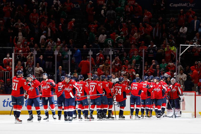 Oct 17, 2024; Washington, District of Columbia, USA; Washington Capitals players celebrate after their game against the Dallas Stars at Capital One Arena. Mandatory Credit: Geoff Burke-Imagn Images