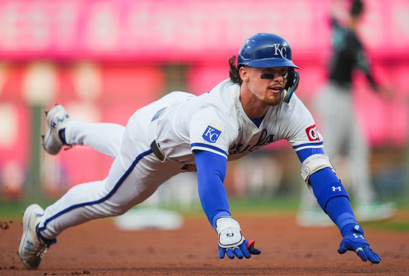 Jul 22, 2024; Kansas City, Missouri, USA; Kansas City Royals shortstop Bobby Witt Jr. (7) dives into third base for a triple during the first inning against the Arizona Diamondbacks at Kauffman Stadium. Mandatory Credit: Jay Biggerstaff-USA TODAY Sports