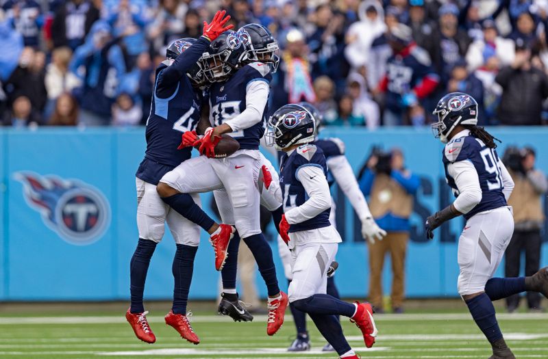 Tennessee Titans safety Terrell Edmunds (38) celebrates with Tennessee Titans safety Mike Brown (44) after intercepting the ball during their NFL football game against the Jacksonville Jaguars Sunday, Jan. 7, 2024, in Nashville, Tenn. (AP Photo/Wade Payne)