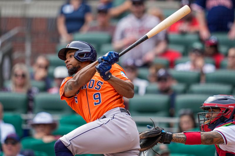 Apr 23, 2023; Cumberland, Georgia, USA; Houston Astros pinch hitter Corey Julks (9) singles to drive in the go ahead run against the Atlanta Braves during the ninth inning at Truist Park. Mandatory Credit: Dale Zanine-USA TODAY Sports