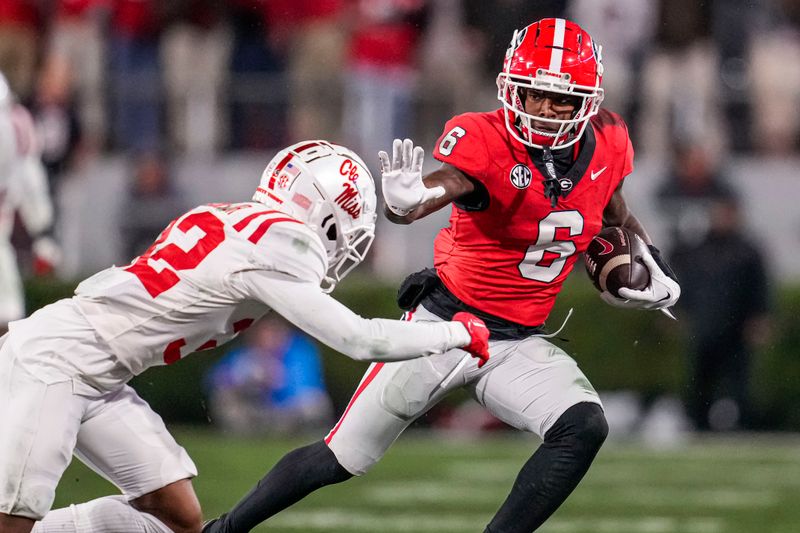 Nov 11, 2023; Athens, Georgia, USA; A Georgia Bulldogs wide receiver Dominic Lovett (6) runs against Mississippi Rebels cornerback Chris Graves Jr. (32) during the second half at Sanford Stadium. Mandatory Credit: Dale Zanine-USA TODAY Sports