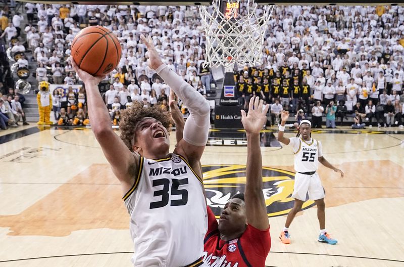 Mar 4, 2023; Columbia, Missouri, USA; Missouri Tigers forward Noah Carter (35) shoots a layup as Mississippi Rebels guard Matthew Murrell (11) defends during the second half at Mizzou Arena. Mandatory Credit: Denny Medley-USA TODAY Sports