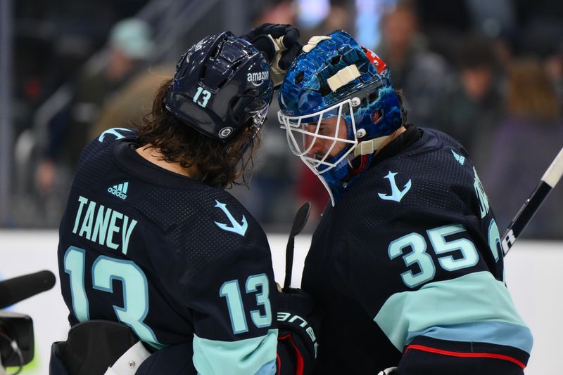 Nov 22, 2023; Seattle, Washington, USA; Seattle Kraken left wing Brandon Tanev (13) and goaltender Joey Daccord (35) celebrate defeating the San Jose Sharks at Climate Pledge Arena. Mandatory Credit: Steven Bisig-USA TODAY Sports