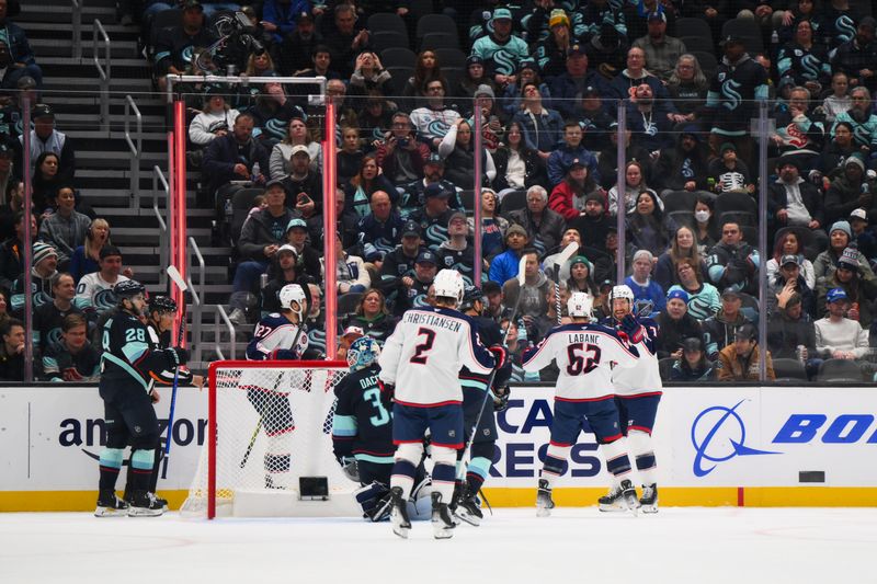 Nov 12, 2024; Seattle, Washington, USA; The Columbus Blue Jackets celebrate after a goal scored by Columbus Blue Jackets center Sean Kuraly (7) against the Seattle Kraken during the first period at Climate Pledge Arena. Mandatory Credit: Steven Bisig-Imagn Images