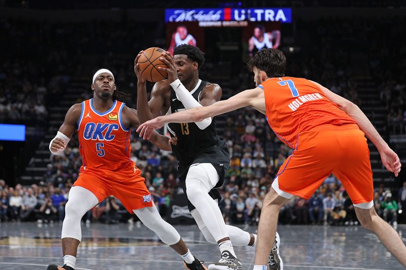 MEMPHIS, TENNESSEE - MARCH 16: Jaren Jackson Jr. #13 of the Memphis Grizzlies drives to the basket between Luguentz Dort #5 of the Oklahoma City Thunder and Chet Holmgren #7 during the second half at FedExForum on March 16, 2024 in Memphis, Tennessee. NOTE TO USER: User expressly acknowledges and agrees that, by downloading and or using this photograph, User is consenting to the terms and conditions of the Getty Images License Agreement. (Photo by Justin Ford/Getty Images)