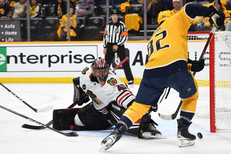 Jan 2, 2024; Nashville, Tennessee, USA; Chicago Blackhawks goaltender Arvid Soderblom (40) blocks a shot by Nashville Predators center Tommy Novak (82) during the third period at Bridgestone Arena. Mandatory Credit: Christopher Hanewinckel-USA TODAY Sports