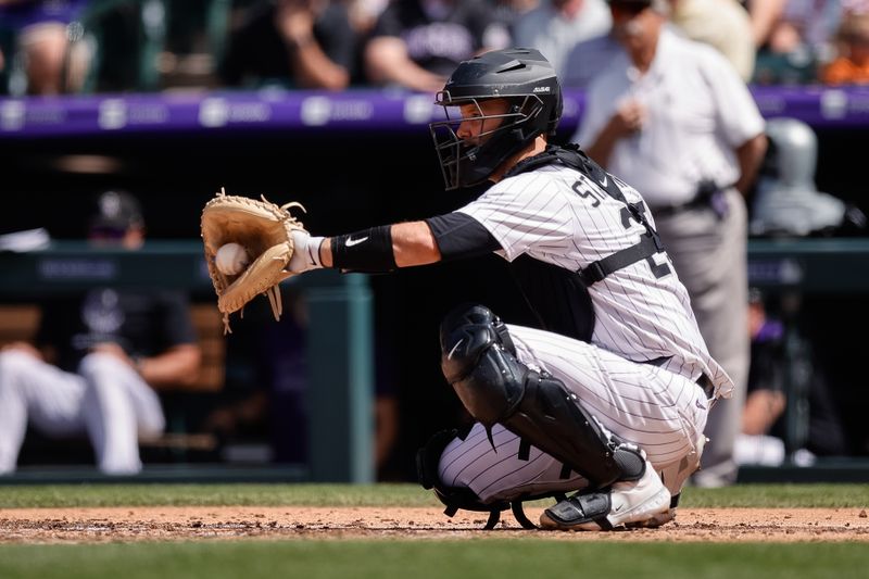 Apr 30, 2025; Denver, Colorado, USA; Colorado Rockies catcher Jacob Stallings (25) catches during a mound visit in the sixth inning against the Colorado Rockies at Coors Field. Mandatory Credit: Isaiah J. Downing-Imagn Images