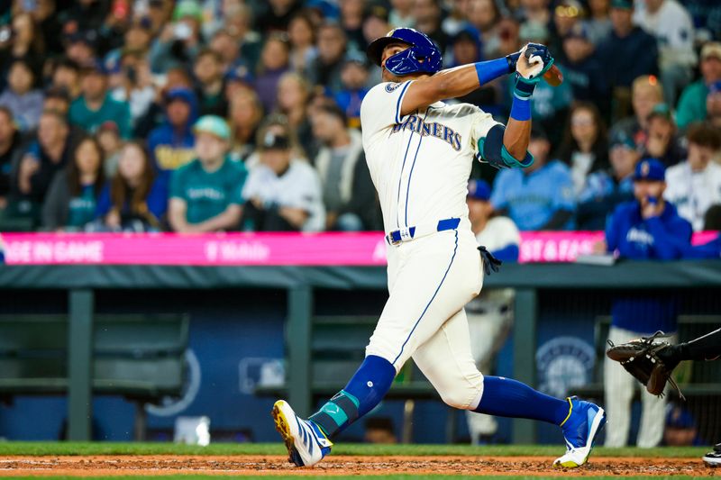 Apr 28, 2024; Seattle, Washington, USA; Seattle Mariners center fielder Julio Rodriguez (44) hits an RBI-single against the Arizona Diamondbacks during the third inning at T-Mobile Park. Mandatory Credit: Joe Nicholson-USA TODAY Sports