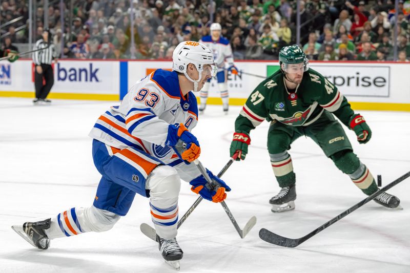 Jan 15, 2025; Saint Paul, Minnesota, USA;  Edmonton Oilers forward Ryan Nugent-Hopkins (93) takes a shot on goal as Minnesota Wild defenseman Declan Chisholm (47) defends during the second period at Xcel Energy Center. Mandatory Credit: Nick Wosika-Imagn Images

