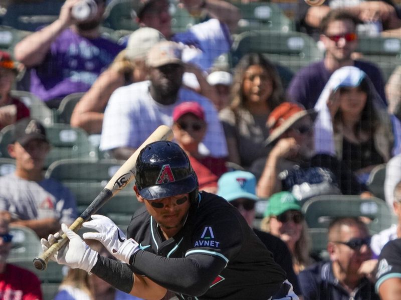 Mar 11, 2024; Salt River Pima-Maricopa, Arizona, USA; Arizona Diamondbacks catcher Gabriel Moreno (14) ducks under the pitch in the third inning against the Oakland Athletics at Salt River Fields at Talking Stick. Mandatory Credit: Rick Scuteri-USA TODAY Sports