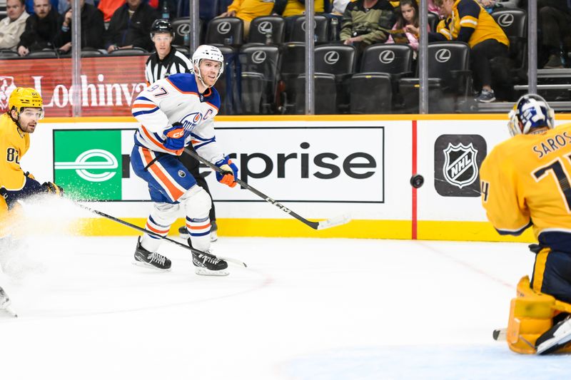 Oct 17, 2024; Nashville, Tennessee, USA;  Nashville Predators goaltender Juuse Saros (74) blocks the short of Edmonton Oilers center Connor McDavid (97) during the second period at Bridgestone Arena. Mandatory Credit: Steve Roberts-Imagn Images