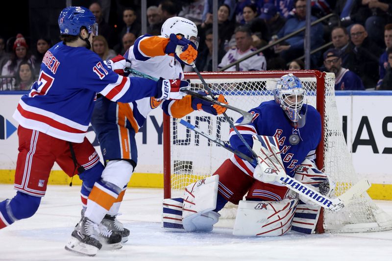 Mar 3, 2025; New York, New York, USA; New York Rangers goaltender Igor Shesterkin (31) makes a save against New York Islanders center Bo Horvat (14) in front of Rangers defenseman Will Borgen (17) during the second period at Madison Square Garden. Mandatory Credit: Brad Penner-Imagn Images