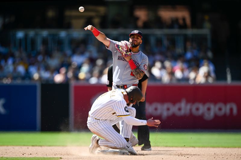 Jun 25, 2025; San Diego, California, USA; Washington Nationals second baseman Luis Garcia Jr. (2) throws over San Diego Padres center fielder Jackson Merrill (3) as he tries to turn a double play during the eighth inning at Petco Park. Mandatory Credit: Denis Poroy-Imagn Images