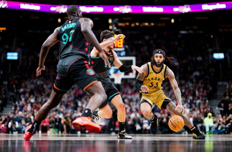 TORONTO, ON - APRIL 7: Gary Trent Jr. #33 of the Toronto Raptors dribbles against Corey Kispert #24 and Eugene Omoruyi #97 of the Washington Wizards during the first half of their basketball game at the Scotiabank Arena on April 7, 2024 in Toronto, Ontario, Canada. NOTE TO USER: User expressly acknowledges and agrees that, by downloading and/or using this Photograph, user is consenting to the terms and conditions of the Getty Images License Agreement. (Photo by Mark Blinch/Getty Images)