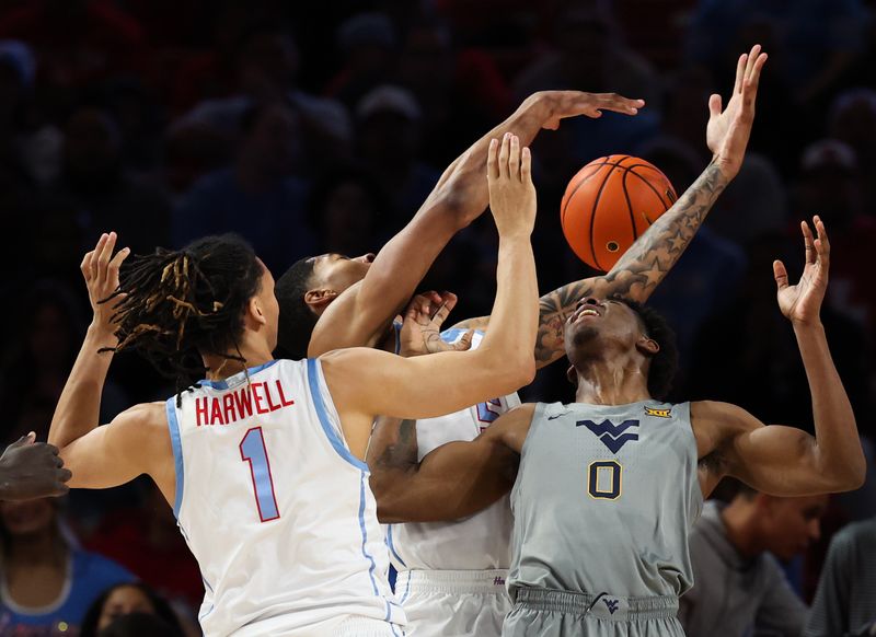 Jan 13, 2026; Houston, Texas, USA;  West Virginia Mountaineers forward Brenen Lorient (0) is trapped by Houston Cougars center Chris Cenac Jr. (5) and Houston Cougars guard Isiah Harwell (1) in the first half at Fertitta Center. Mandatory Credit: Thomas Shea-Imagn Images