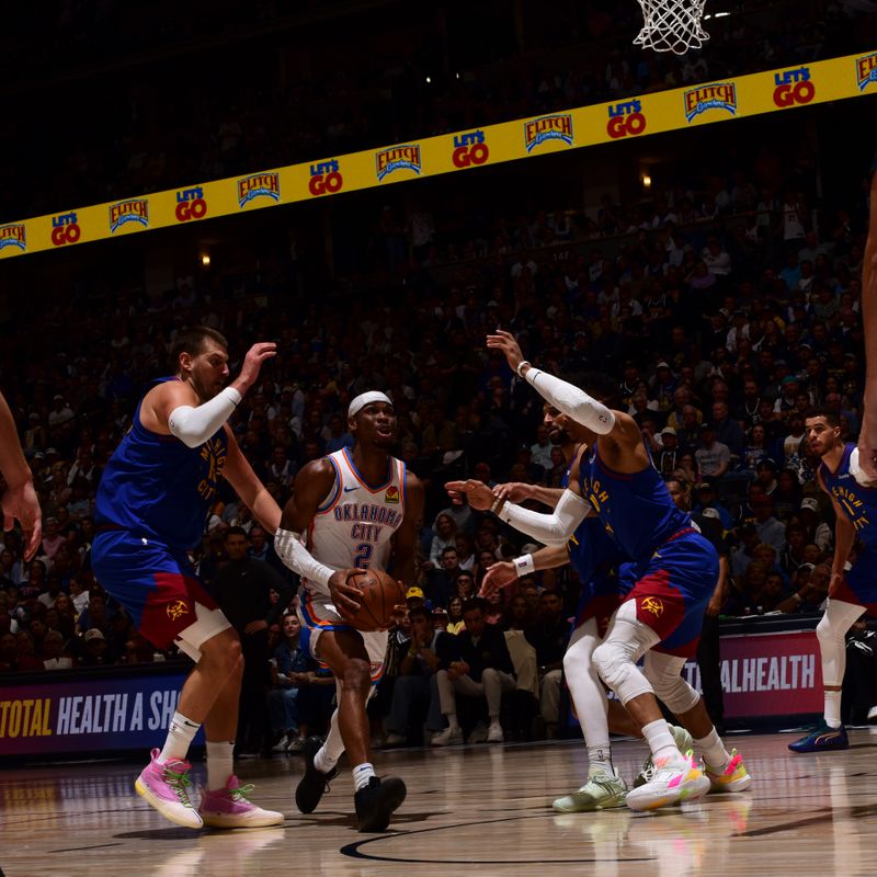 DENVER, CO - MAY 9:   Shai Gilgeous-Alexander #2 of the Oklahoma City Thunder drives to the basket during the game against the Denver Nuggets during Round Two Game Three of the 2025 NBA Playoffs on May 9, 2025 at Ball Arena in Denver, Colorado. NOTE TO USER: User expressly acknowledges and agrees that, by downloading and/or using this Photograph, user is consenting to the terms and conditions of the Getty Images License Agreement. Mandatory Copyright Notice: Copyright 2025 NBAE (Photo by Garrett Ellwood/NBAE via Getty Images)