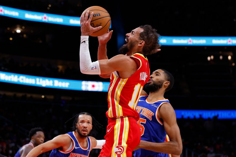 ATLANTA, GEORGIA - NOVEMBER 6: Trae Young #11 of the Atlanta Hawks goes up for a shot during the fourth quarter against the New York Knicks at State Farm Arena on November 6, 2024 in Atlanta, Georgia. NOTE TO USER: User expressly acknowledges and agrees that, by downloading and or using this photograph, User is consenting to the terms and conditions of the Getty Images License Agreement. (Photo by Todd Kirkland/Getty Images)