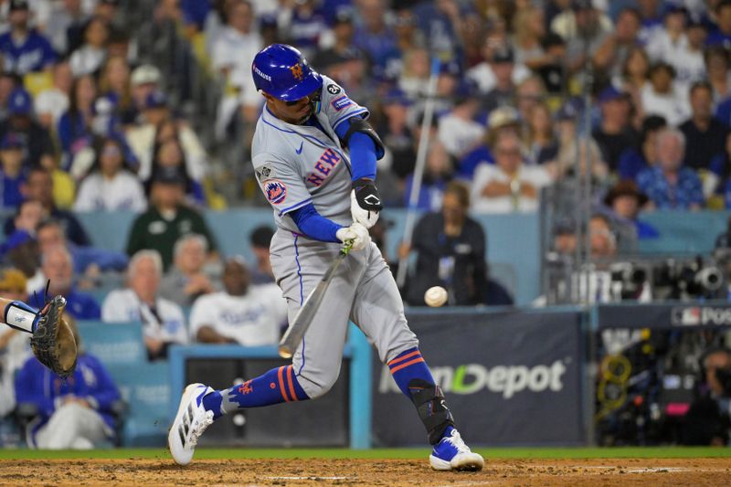 Oct 20, 2024; Los Angeles, California, USA; New York Mets third baseman Mark Vientos (27) hits a two run home run in the fourth inning against the Los Angeles Dodgers during game six of the NLCS for the 2024 MLB playoffs at Dodger Stadium. Mandatory Credit: Jayne Kamin-Oncea-Imagn Images