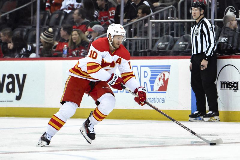 Feb 8, 2024; Newark, New Jersey, USA; Calgary Flames center Jonathan Huberdeau (10) skates with the puck during the first period against the New Jersey Devils at Prudential Center. Mandatory Credit: John Jones-USA TODAY Sports