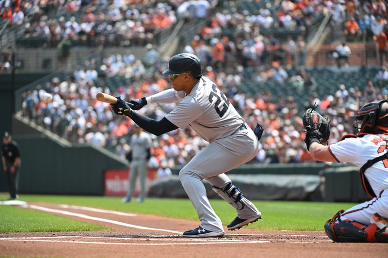 Jul 14, 2024; Baltimore, Maryland, USA;  New York Yankees outfielder Juan Soto (22) bunts during the first inning against the Baltimore Orioles at Oriole Park at Camden Yards. Mandatory Credit: James A. Pittman-USA TODAY Sports