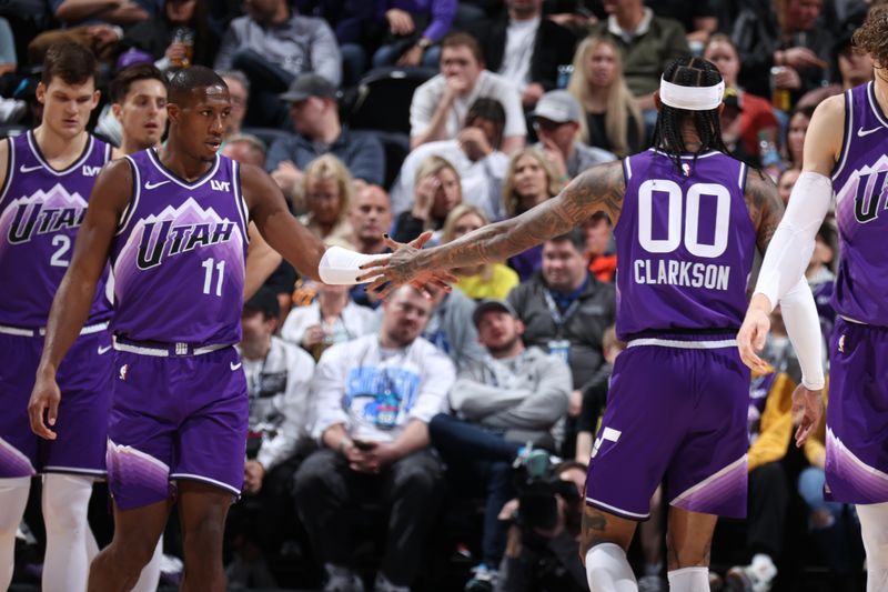 SALT LAKE CITY, UT - FEBRUARY 25: Kris Dunn #11 of the Utah Jazz and Jordan Clarkson #00 of the Utah Jazz high five during the game against the San Antonio Spurs on February 25, 2024 at vivint.SmartHome Arena in Salt Lake City, Utah. NOTE TO USER: User expressly acknowledges and agrees that, by downloading and or using this Photograph, User is consenting to the terms and conditions of the Getty Images License Agreement. Mandatory Copyright Notice: Copyright 2024 NBAE (Photo by Melissa Majchrzak/NBAE via Getty Images)