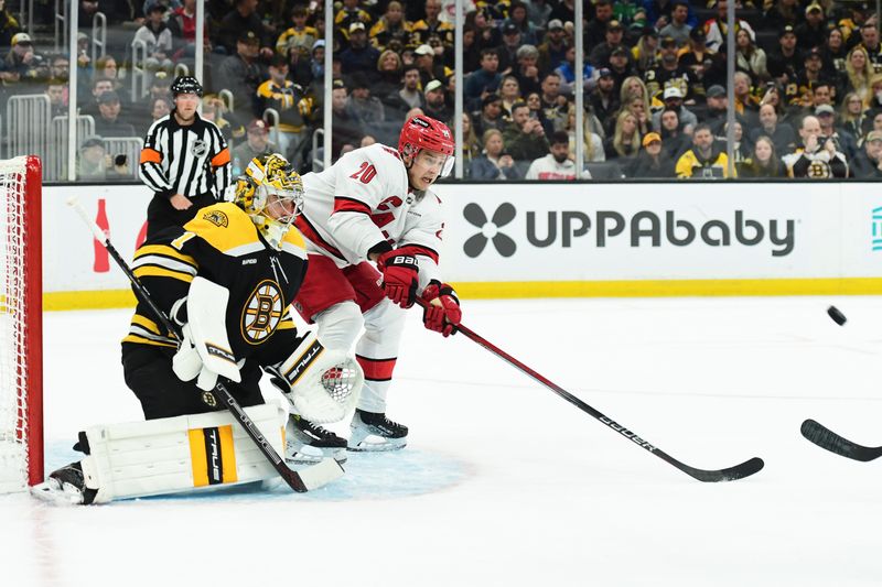 Apr 5, 2025; Boston, Massachusetts, USA; Carolina Hurricanes center Sebastian Aho (20) looks for a rebound in front of Boston Bruins goaltender Jeremy Swayman (1) during the second period at TD Garden. Mandatory Credit: Bob DeChiara-Imagn Images